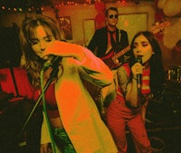 a woman is singing into a microphone