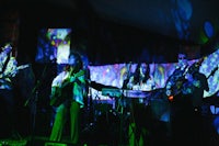 a group of people playing music in a dark room
