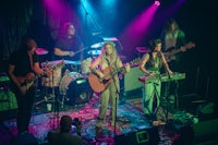 a group of people playing music on stage